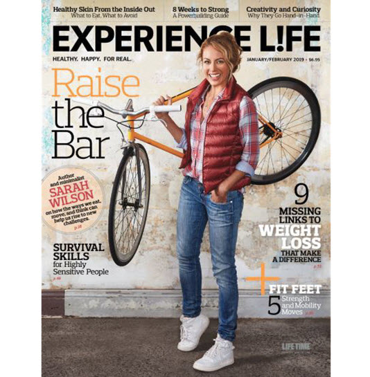 magazine cover with a woman holding a bike