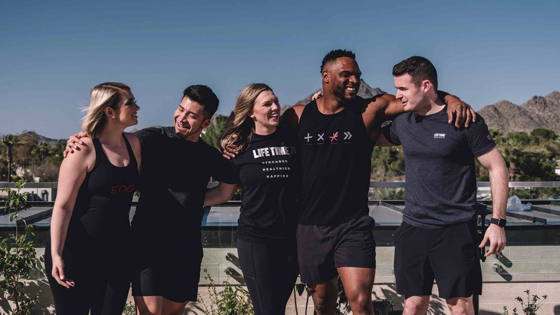 five people with arms around each other post-workout
