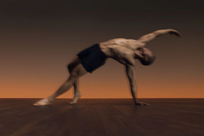 Man in side angle pose with chest opener during flow yoga class at Life Time